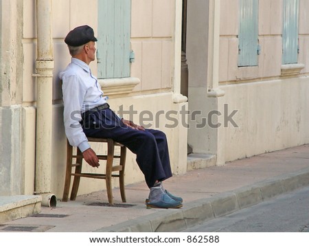 old man smoking outside Mediterranean