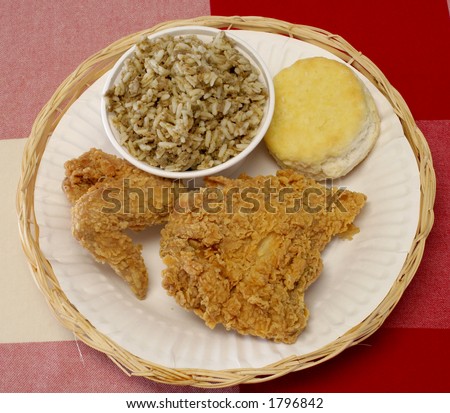 Full view of fried chicken, biscuit and dirty rice meal.