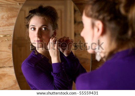 Portrait of a beautiful woman in front of mirror.