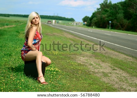 Sexy young woman near the road. Outdoor shooting.