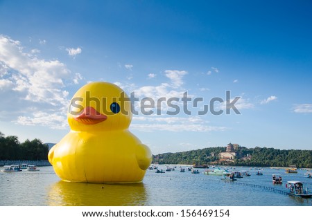 BEIJNG, CHINA - OCT 1 2013: Giant rubber duck in the summer palace. The rubber duck  is any of several giant floating sculptures designed by Dutch artist Florentijn Hofman.