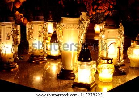 Group of candles on grave during All Saint\'s Day in Poland