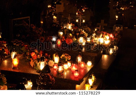 Candle flames illuminating on Polish cemetery during All Saint\'s Day