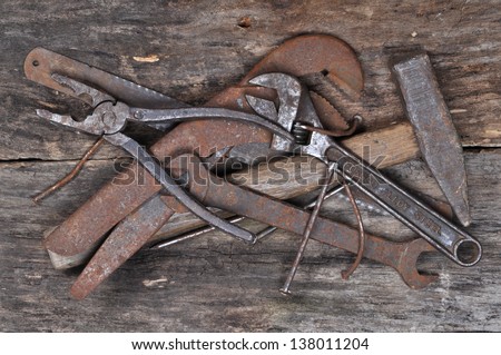 Complete of old tools on a wooden background