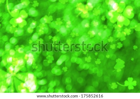Green bokeh effect with blurred clovers. St. Patrick\'s Day background