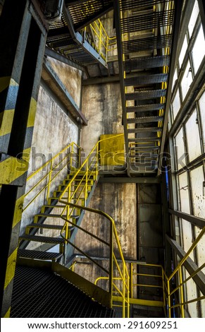 Metal stairs in factory in yellow and black