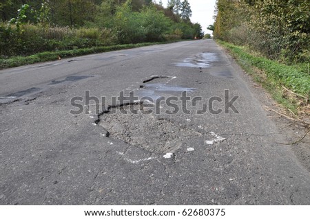Road damaged after winter. A hole in the road.