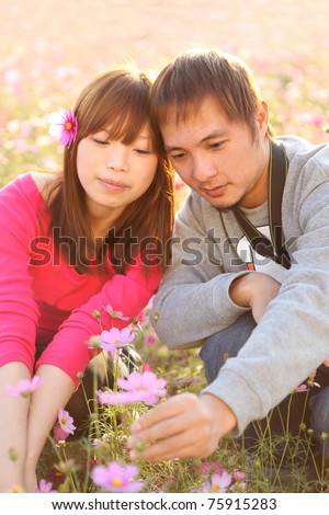 Happy chinese couple smiling in love on outdoor park