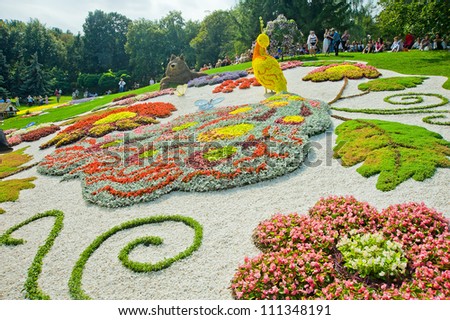 KIEV, UKRAINE - AUGUST 24: The sculpture of the fantastic fire-bird with majestic plumage and long tail made of flowers  at the 57th annual flower exhibition on August 24, 2012 in Kiev, Ukraine.