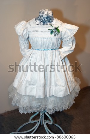 KIEV, UKRAINE - APRIL 16: An original white girl\'s dress is on display at the museum exhibit of Marina Ivanova\'s private collection of antique woman\'s clothes on April 16, 2011 in Kiev, Ukraine.