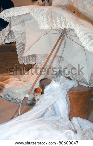 KIEV, UKRAINE - APRIL 16: A composition with sunshade is on display at the museum exhibit of Marina Ivanova\'s private collection of antique woman\'s clothes on April 16, 2011 in Kiev, Ukraine.