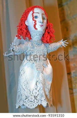 KIEV, UKRAINE - JANUARY 09: A collectible doll, which resembles an angel with orange hair, is on display at the Angel Age exhibit of Author\'s Dolls on January 09, 2012 in Kiev, Ukraine.