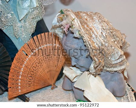 KIEV, UKRAINE - APRIL 16: Woman bust with fine bonnet and fan are on display at the museum exhibit of Marina Ivanova's private collection of antique woman's clothes on April 16, 2011 in Kiev, Ukraine