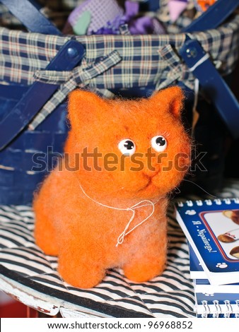 KIEV, UKRAINE - FEBRUARY 26: A collectible doll, which resembles a plush fluffy orange kitten, is on display at the Fashion Doll International exhibit on February 26, 2012 in Kiev, Ukraine.