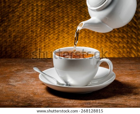 Tea being poured into tea cup