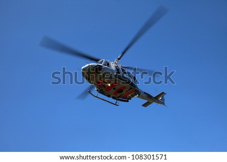 Search and Rescue Training  with a winchman hanging on the end of a wire RAF Valley Anglesey UK