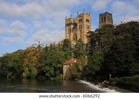 Reflections of Durham Cathedral and autumn trees in the river Wear