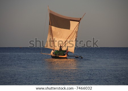 Malagasy fishermen and their outrigger canoes pirogue some of which had makeshift sails