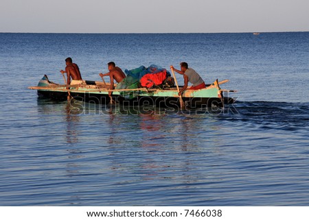 Malagasy fishermen and their outrigger canoes pirogue some of which had makeshift sails