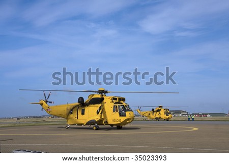 A Seaking search and rescue helicopter taking off from an airfield for a job