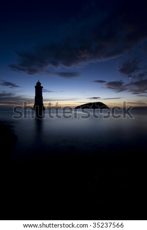 Penmon Point Sunrise with Puffin Island a lighthouse and North Wales coastline in the background