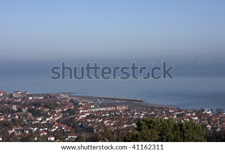 View down to Colwyn Bay with the sea houses and wind turbines