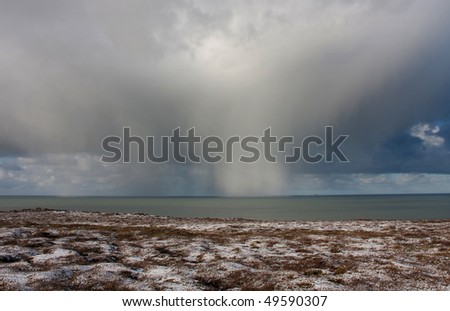 Hail storm clouds blowing past over the Irish Sea off the Isle of Anglesey