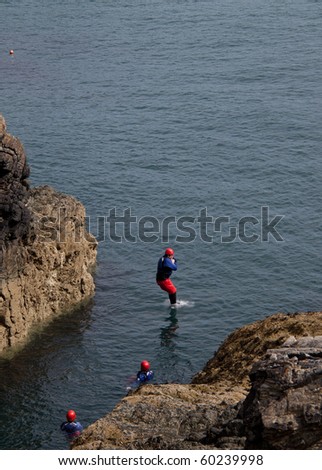 Coasteering where organised groups jump off cliffs into the sea The Range Isle of Anglesey