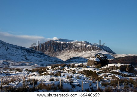 View to Moel Ddu  in winter with a sheep shelter in the foreground Snowdonia