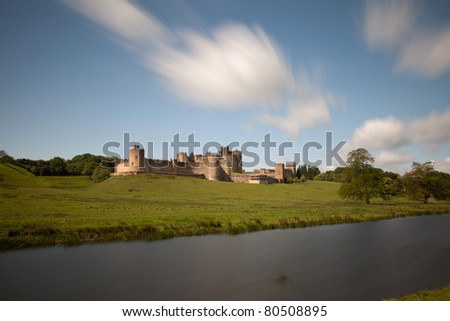 Alnwick Castle on the River Aln with the Lion bridge spanning it Northumberland England Uk