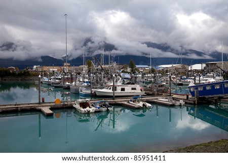 Valdez Harbour with fishermen gutting salmon recently caught Alaska America