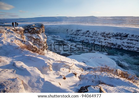 Golden Waterfall   winter views of Iceland in the Arctic Circle with sunshine