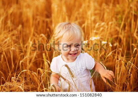 Cute little girl on the meadow in summer day. Art processing.