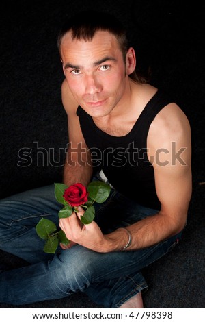 A sexy young man with rose undressing, isolated