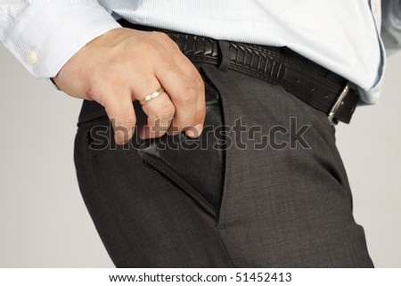 Man businessman pulls the wallet from his trouser pocket, close-up