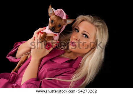 stock photo Women in pink with little dog pussy dog looks in the