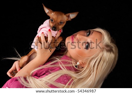 stock photo Women in pink playing with little dog pussy