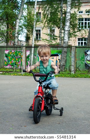 Young boy on his bike outside