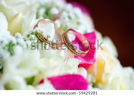 stock photo Wedding rings with flowers selective focus soft focus