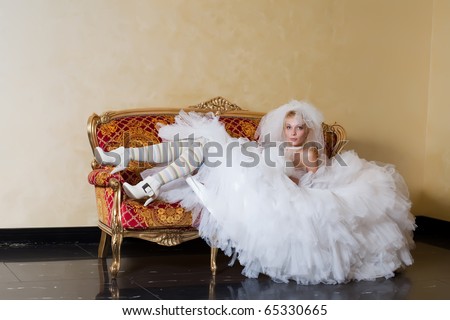 bride relaxing on love seat.