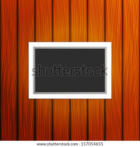 Decorative frame on a wooden background. EPS version is available as ID 152779517.