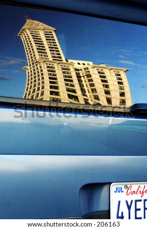 reflection of smith tower (seattle) in car window