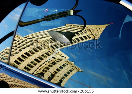 reflection of smith tower (seattle) in car window