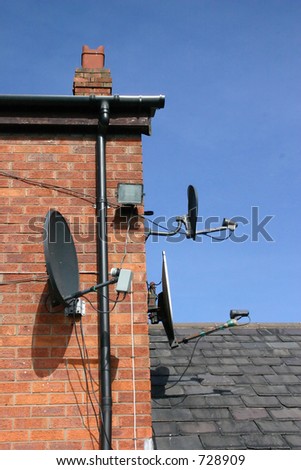 3 Small Satellite Dishes on the SIde of a House