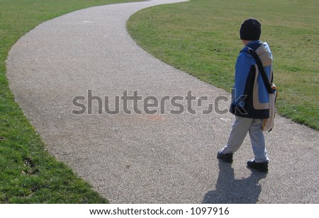 Boy on Curved Stone Chip Path on Grass Lawn in Park