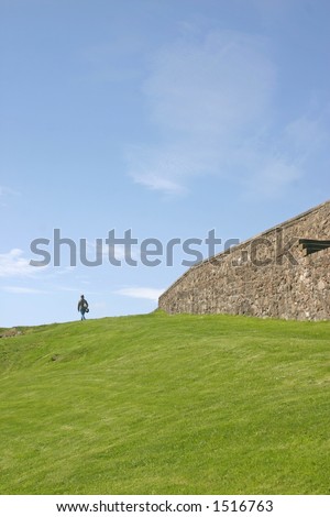 Woman Walking on Grass Bank Stirling Castle in Scotland UK
