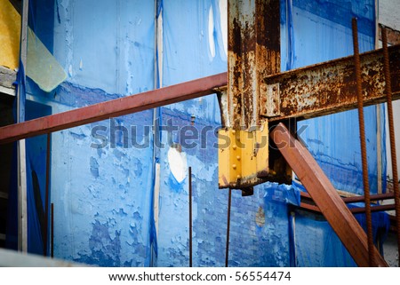 Rusty beams and poorly supported column at construction site