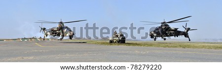 PRETORIA, SOUTH AFRICA - MAY 21. Two Rooivalk helicopters and a Rooikat infantry vehicle from the S.A. Defence Force perform at the South Africa Air Force Museum Air Show on May 21, 2011 in Pretoria, South Africa.