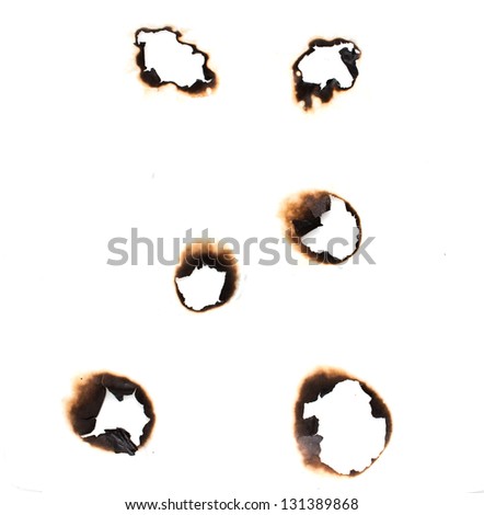Collection of burnt holes in a piece of paper isolated on white background