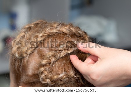 braided hairstyle of hair in a beauty salon